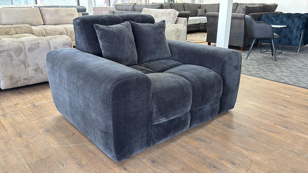 Black sofa in a showroom with other furniture in the background