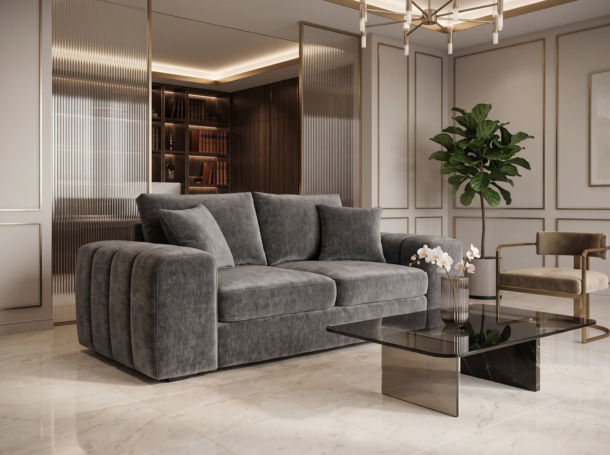 A modern gray velvet sofa with pleated armrests in a luxurious, contemporary living room featuring gold-trimmed walls, a glass coffee table, and a potted plant.