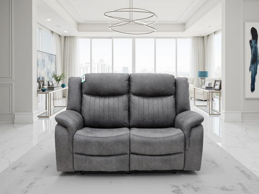 Gray sofa in a modern living room with large windows and minimal decor.