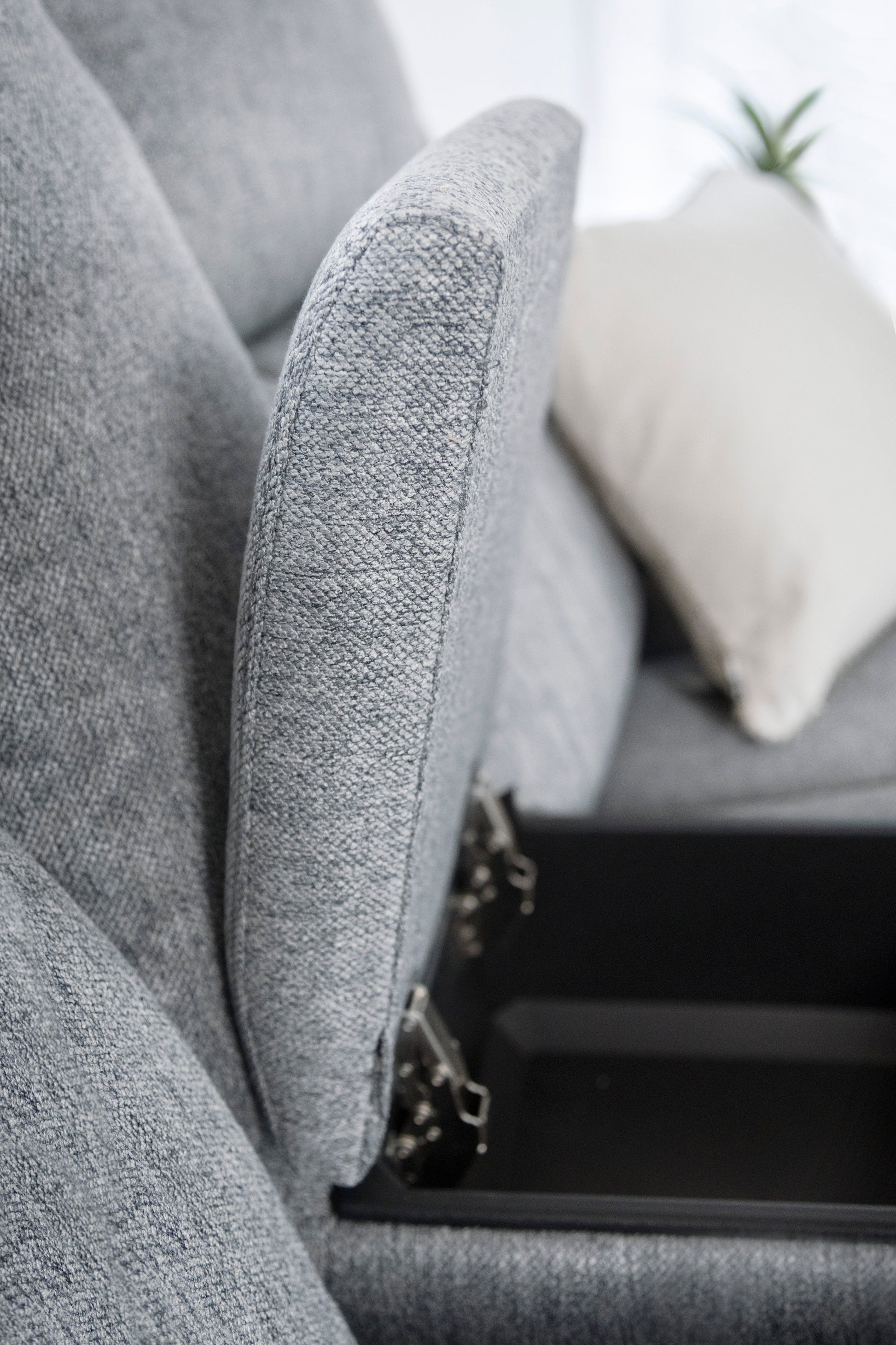 Gray upholstered chair with a blurred background