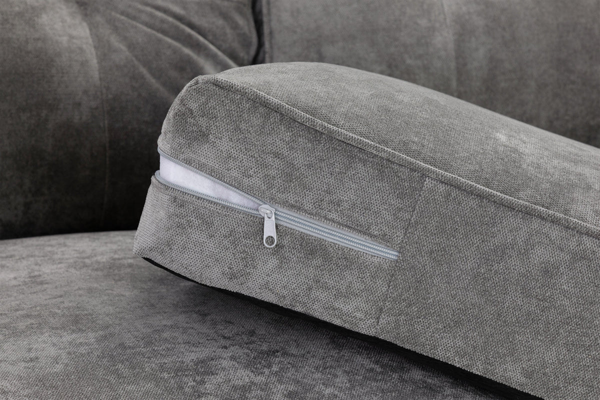 Gray sofa with a cushion featuring a zipper detail