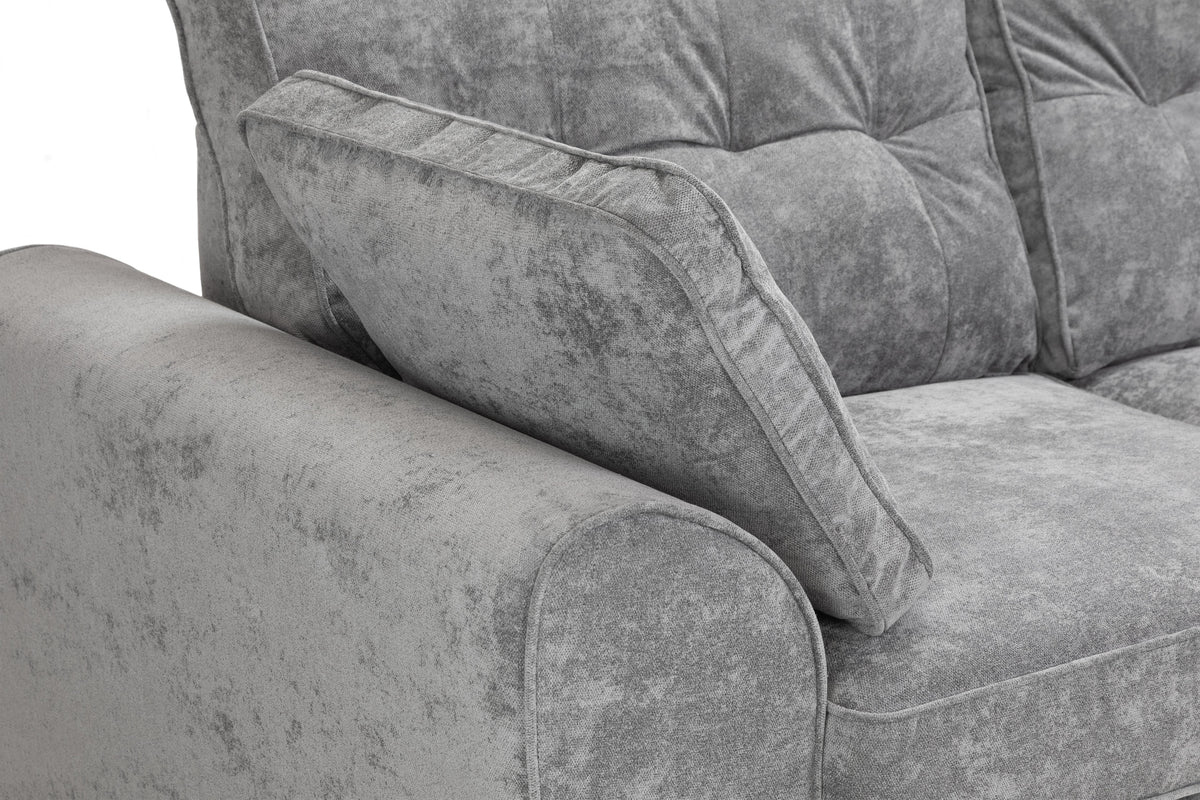 Gray textured sofa with a close-up of the armrest and cushion.