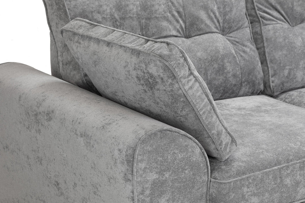 Gray textured sofa with a close-up of the armrest and cushion.