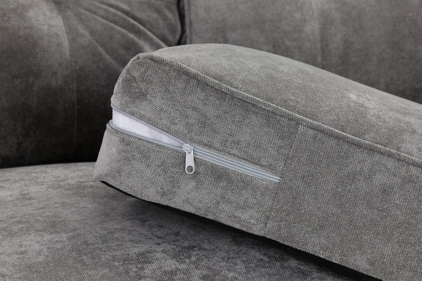 Gray cushion with a zipper on a gray sofa