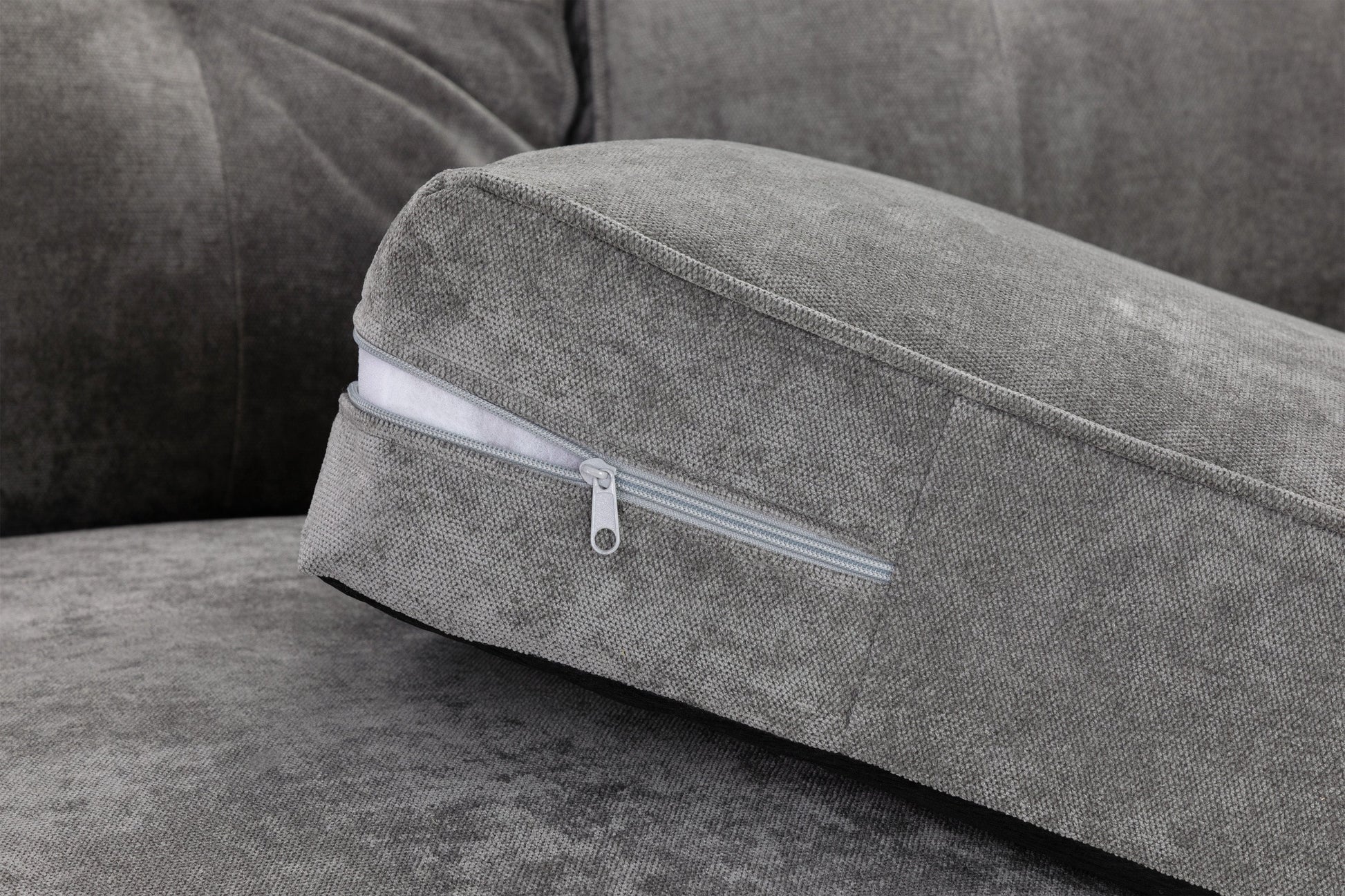 Gray cushion with a zipper on a gray sofa