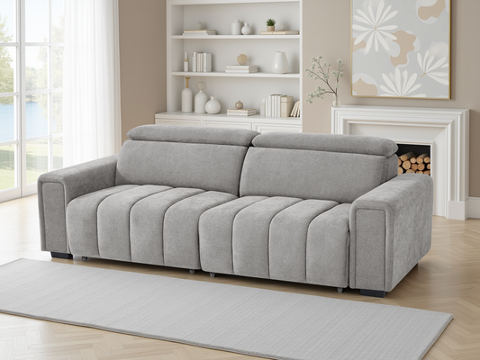 Gray sofa in a living room with a fireplace and shelves.