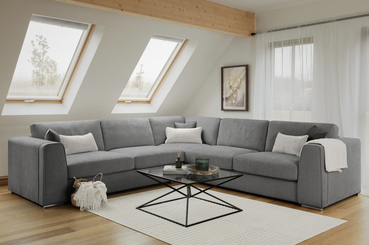 Gray sectional sofa in a living room with a coffee table and decorative items.