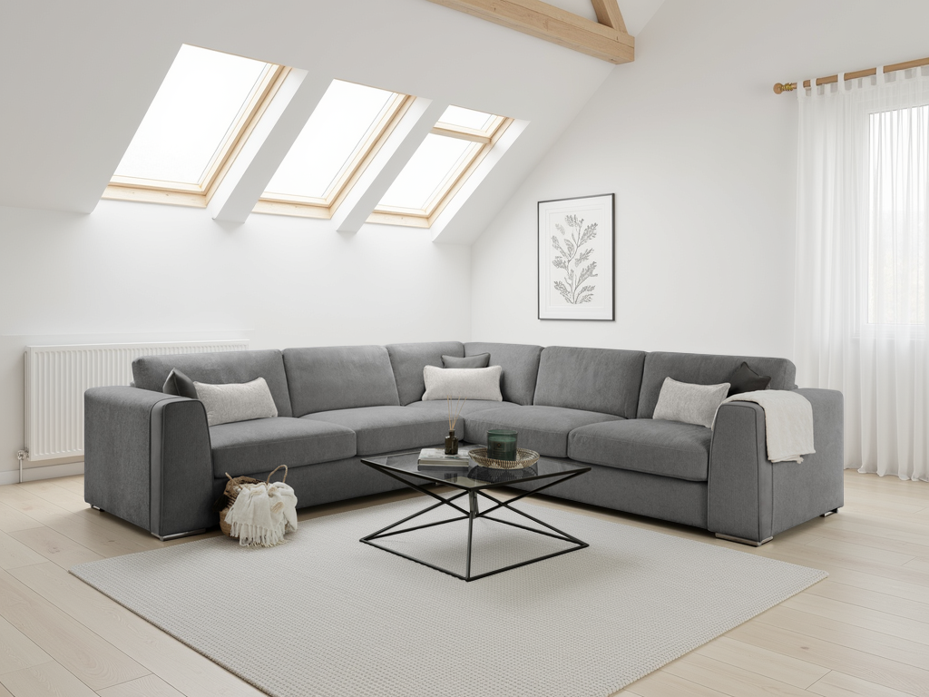 Gray sectional sofa in a modern living room with skylights and a rug.