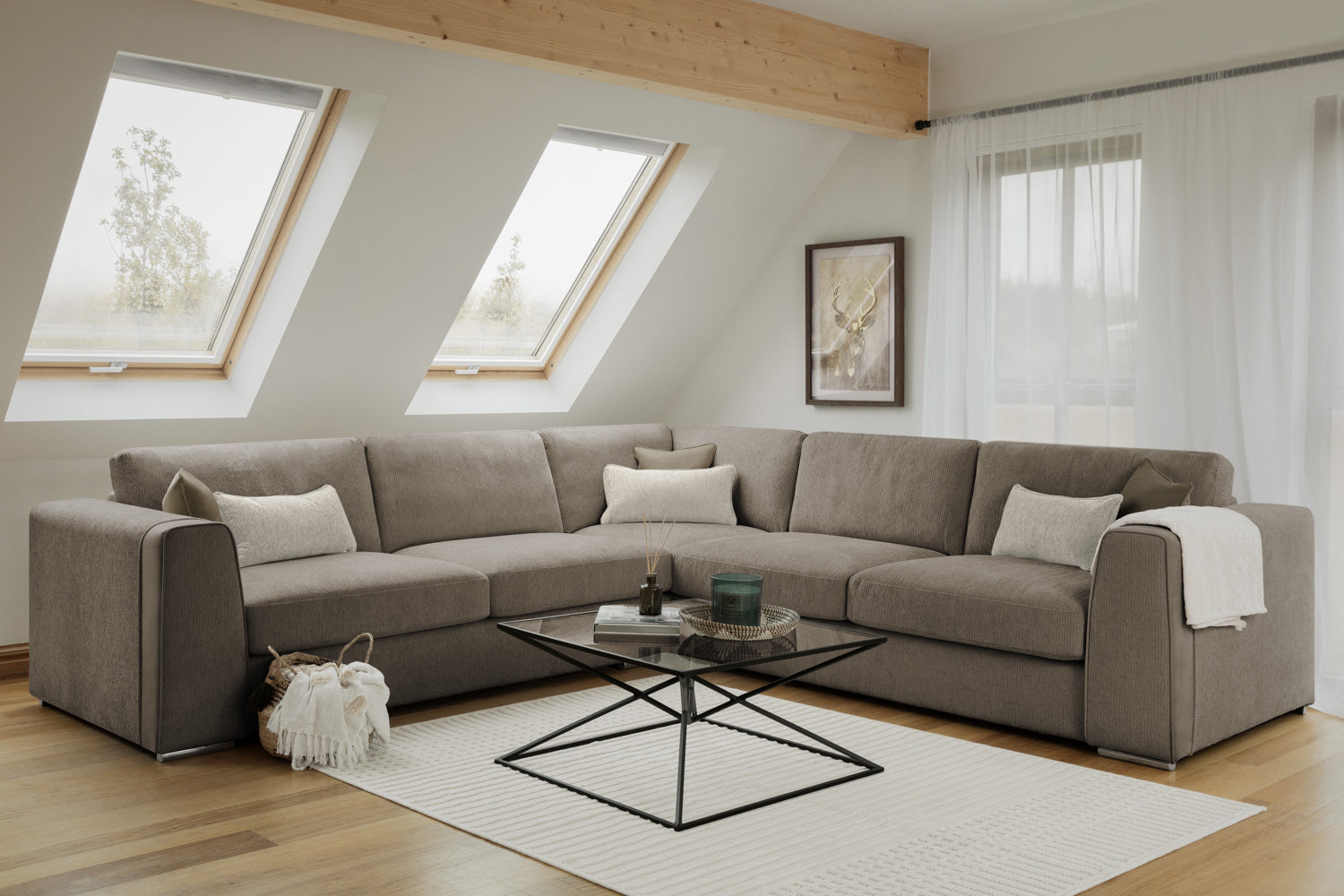 Gray sectional sofa in a living room with a coffee table and decorative items.