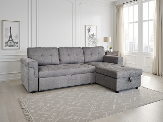 Gray sectional sofa in a living room with white walls and a rug.