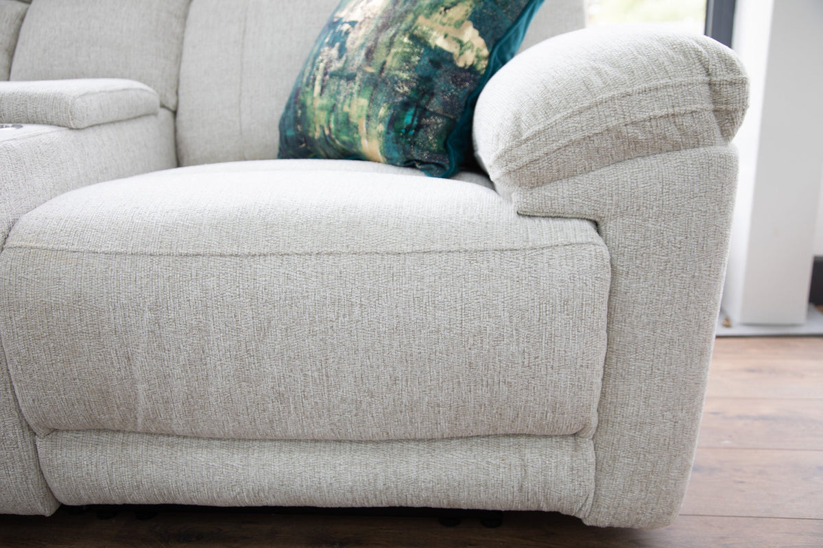 Beige sofa with a decorative pillow on a wooden floor