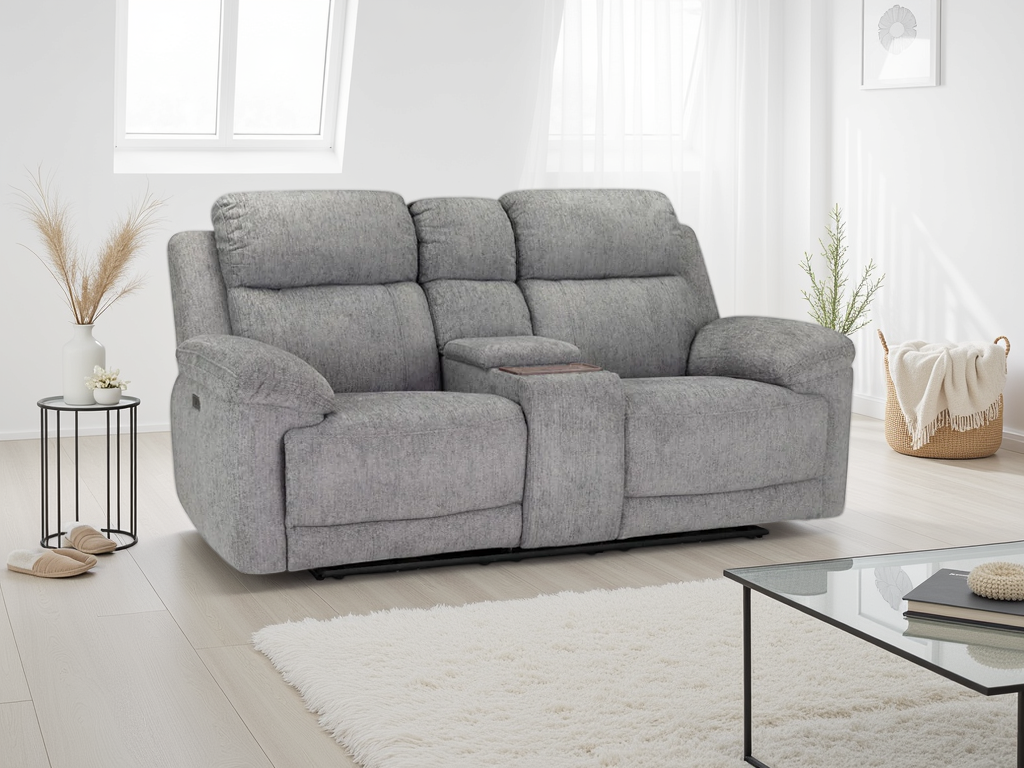 Gray sofa in a modern living room with a glass coffee table and decorative items.