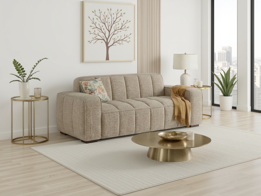 Beige sofa in a living room with a gold coffee table and decorative elements.