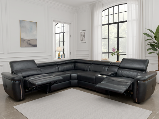Black leather sectional sofa in a living room with white walls and large windows.
