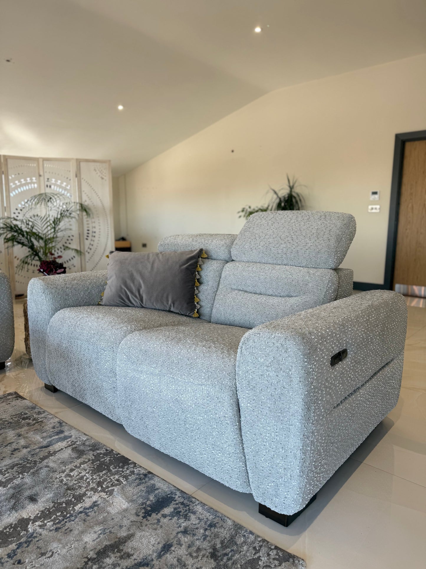 Gray sofa in a living room setting with decorative elements.