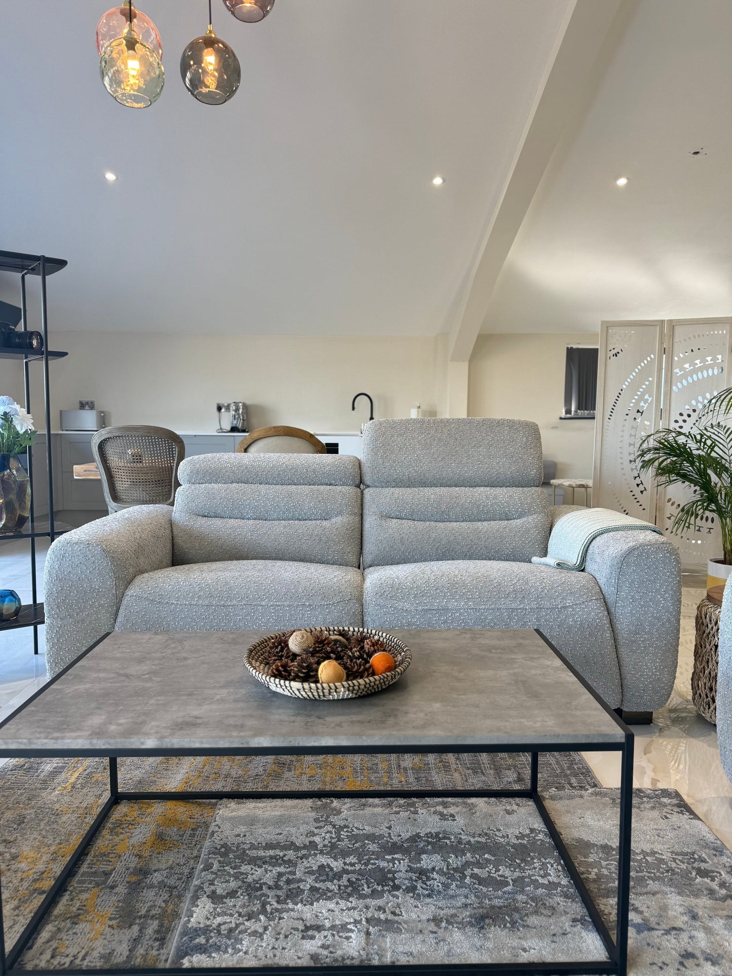 Living room with a gray sofa, coffee table, and decorative elements.