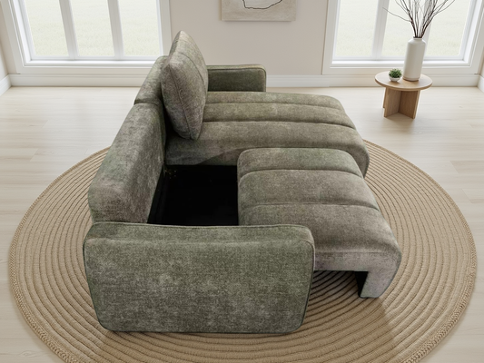 A modern L-shaped sectional sofa in textured sage green upholstery, with a chaise lounge on one side.