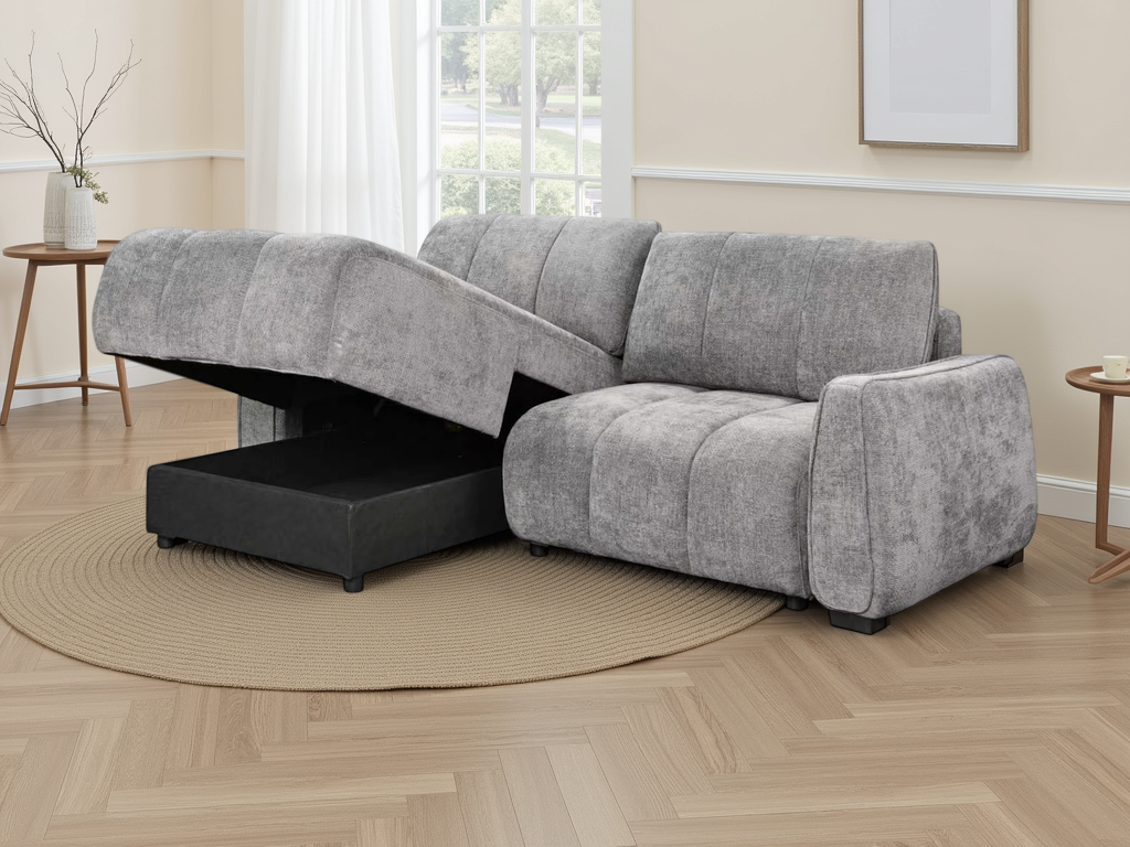 A light grey textured fabric sectional sofa with a chaise lounge on one end.