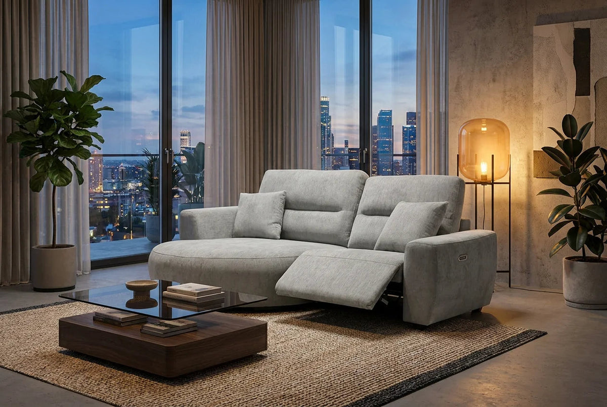 A light gray upholstered reclining sofa in a modern living room.