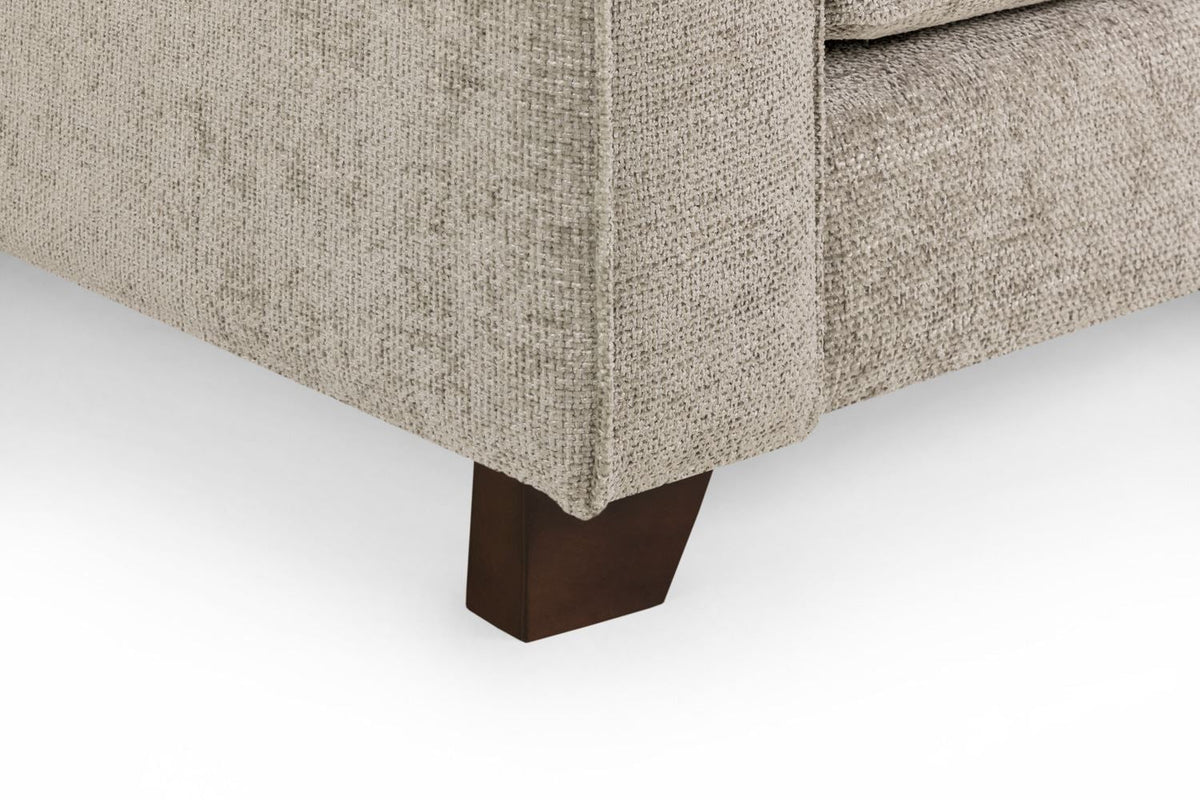 Close-up of a beige upholstered chair with a dark brown wooden leg on a white background