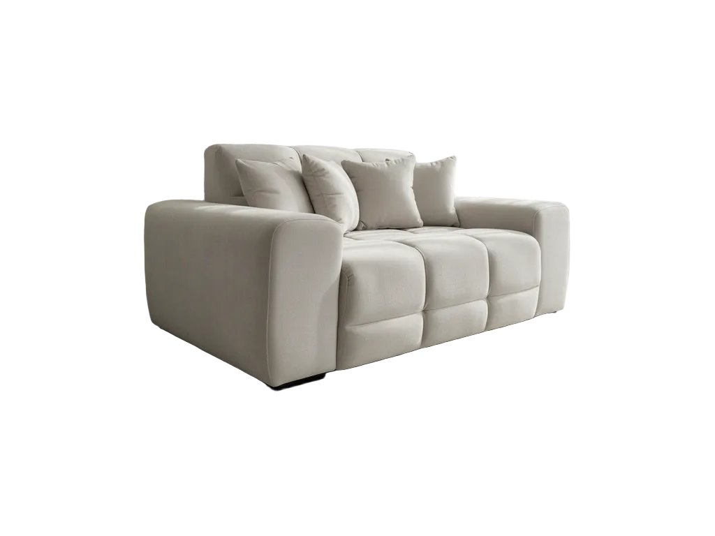 A modern three-seater sofa upholstered in a light beige fabric, featuring a low-profile rectangular silhouette, chunky armrests, and four matching throw pillows, shown against a plain white background.