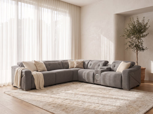A modern L-shaped sectional sofa upholstered in textured grey fabric. 