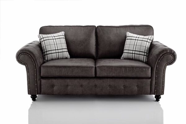 charcoal sofa with plaid cushions on a white background