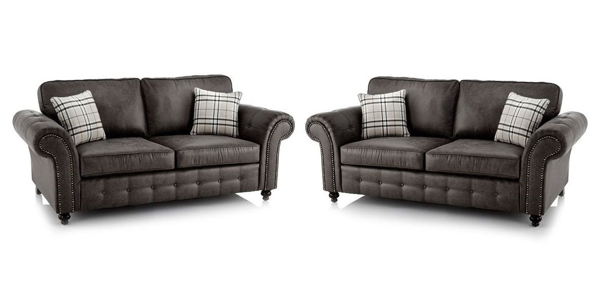 A matching two-piece sofa set consisting of a two-seater loveseat and a three-seater loveseat in dark charcoal white background.
