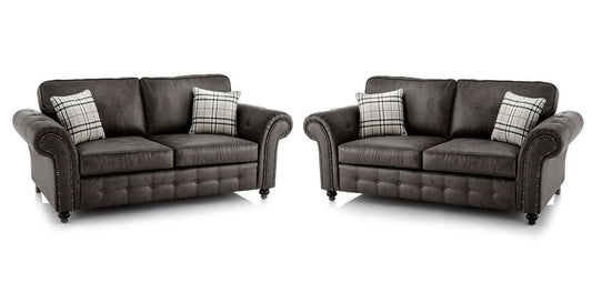 A matching two-piece sofa set consisting of a two-seater loveseat and a three-seater loveseat in dark charcoal white background.