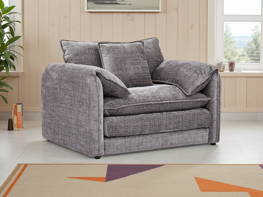 Gray sofa in a living room setting with a plant and window in the background.
