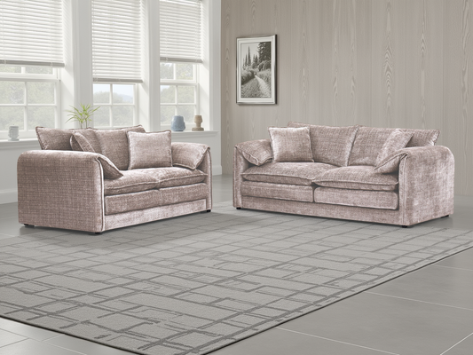 Two patterned sofas in a room with large windows and a framed picture on the wall.