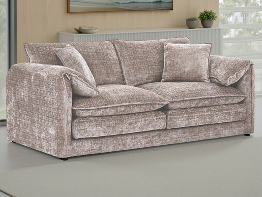 Beige textured sofa in a room with a painting and plants on a shelf.