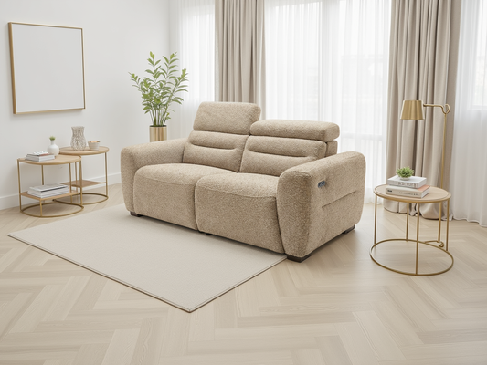 Beige sofa in a living room with gold side tables and white curtains.
