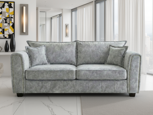 Gray sofa in a modern living room with large windows and abstract art on the wall.