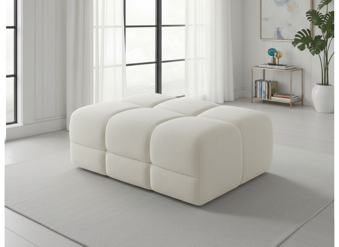 White modular sofa in a modern living room with large windows and minimal decor.
