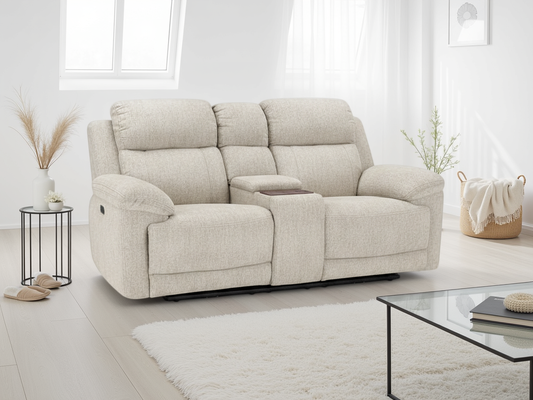 Beige sofa in a modern living room with a glass coffee table and decorative items.
